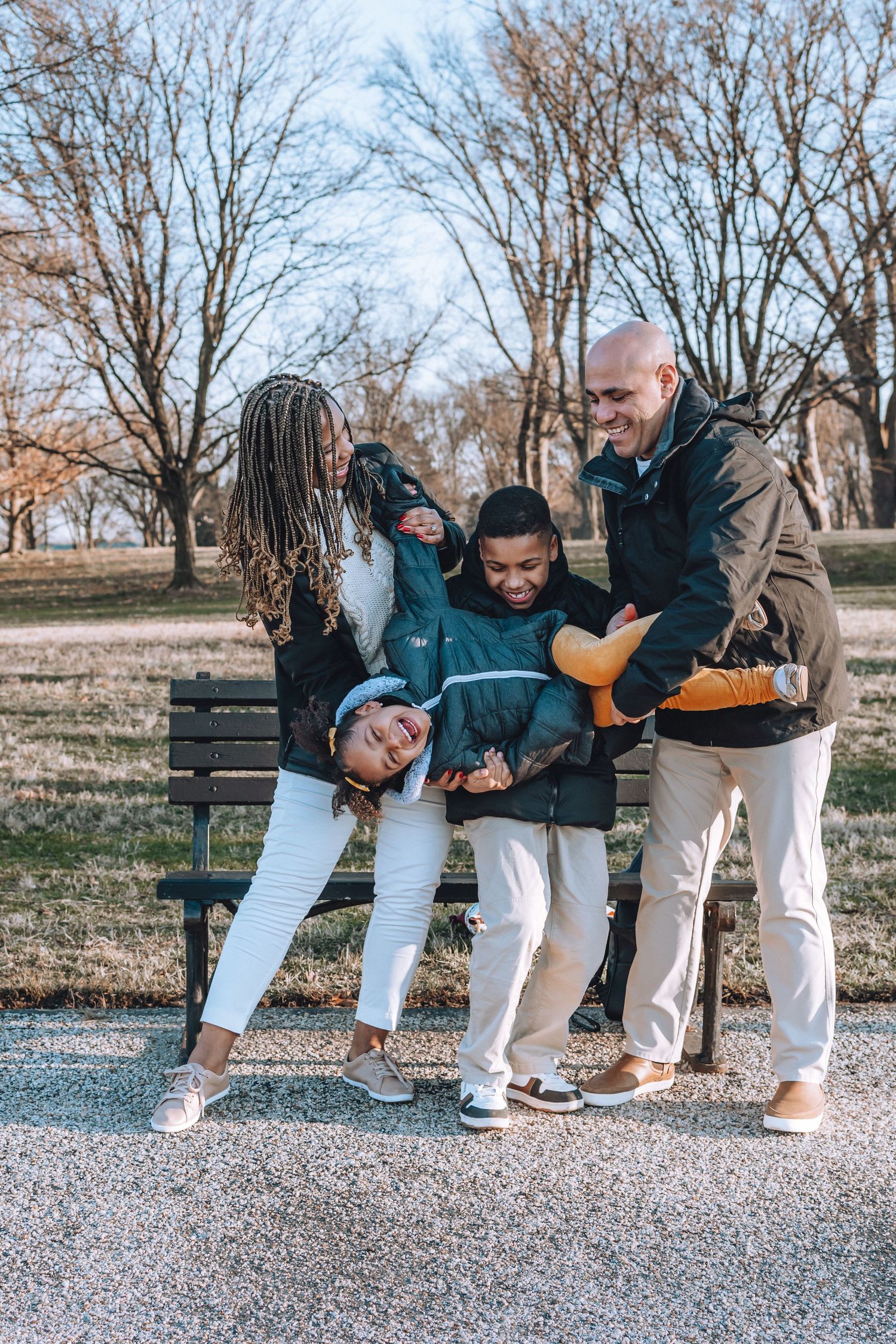 A candid moment of laughter and fun by a park bench during autumn.