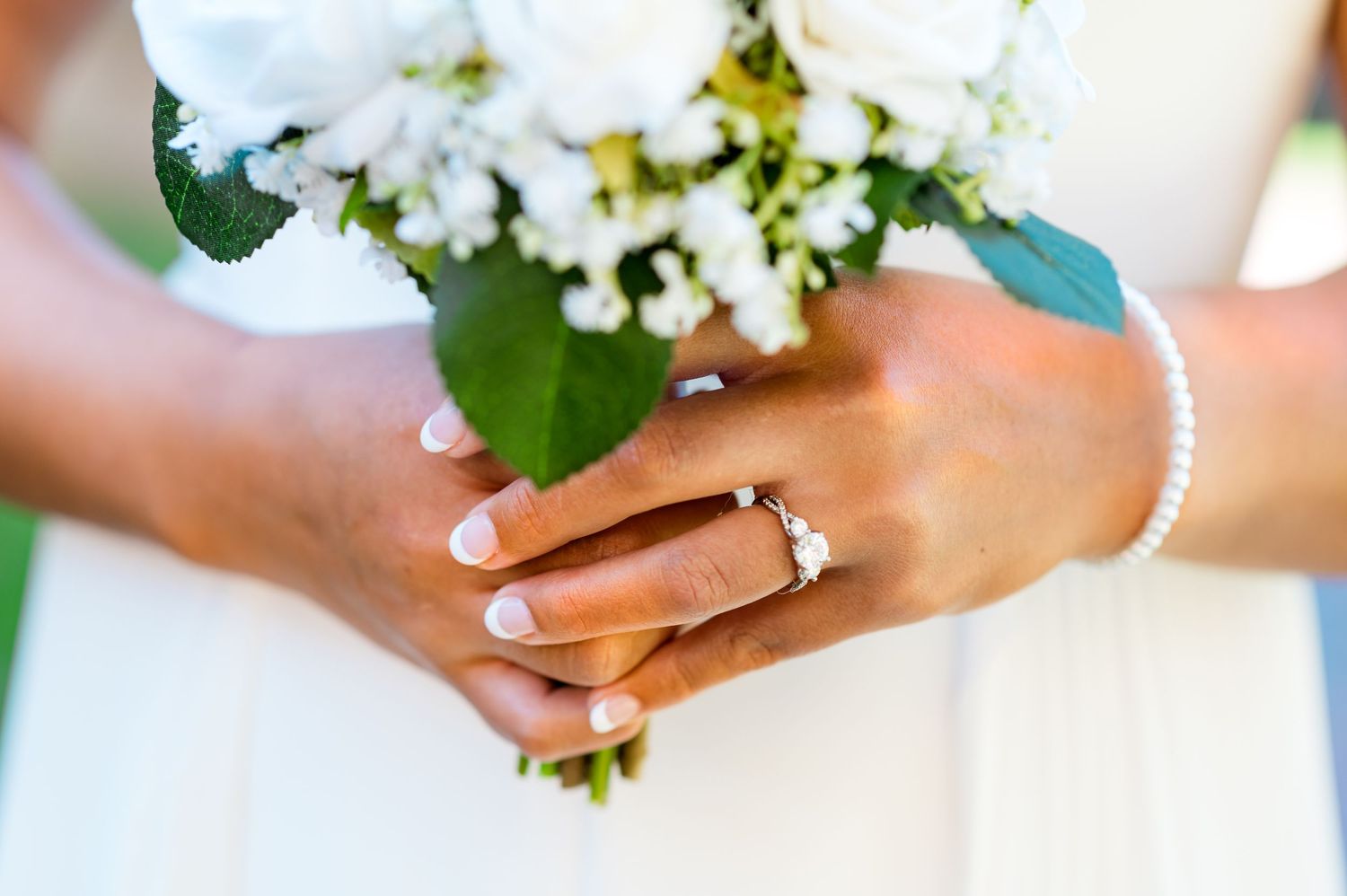 Simple ring photos with delicate white flowers on a white background showcase an elegant wedding ring set.