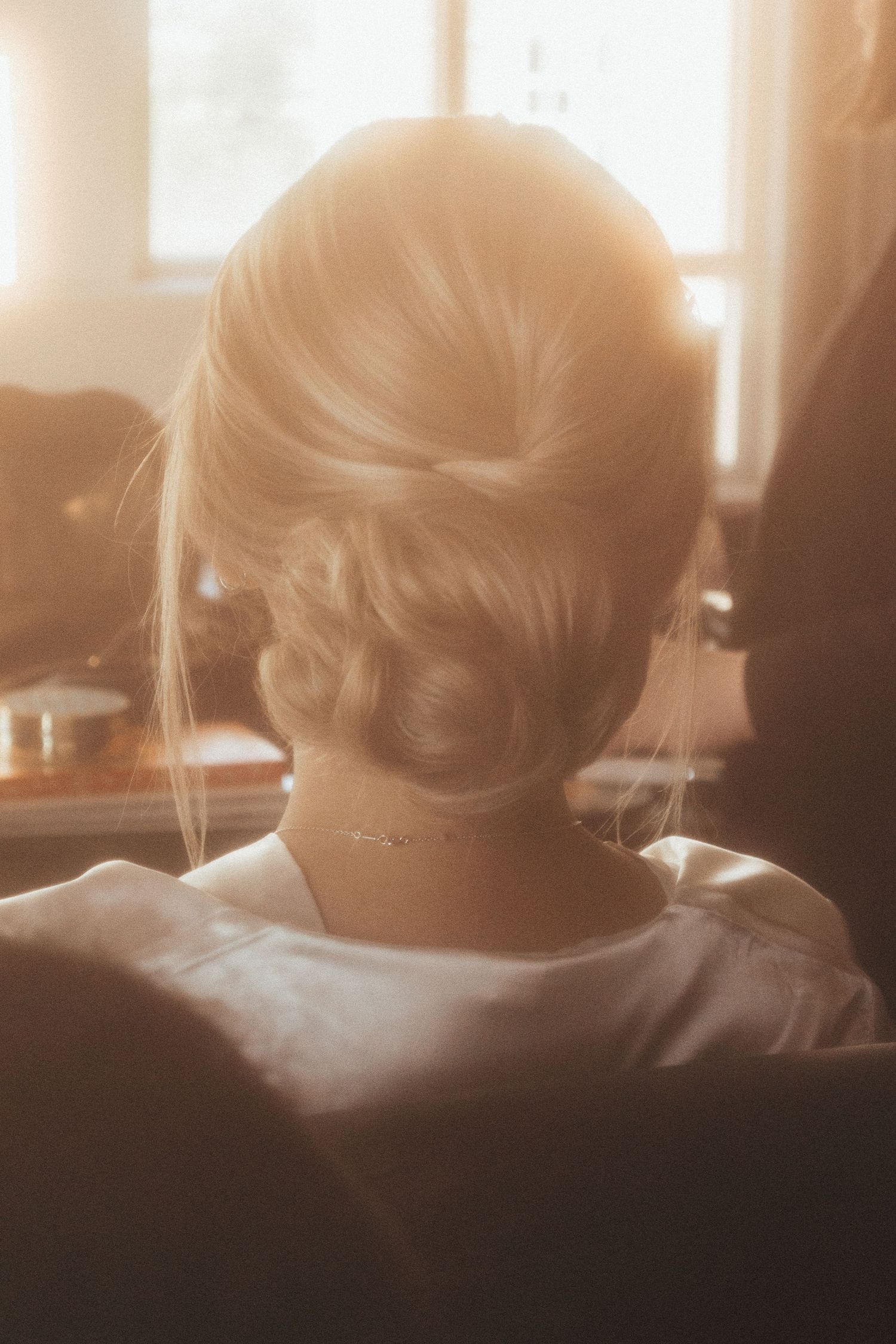 A soft sepia-toned montage shows several profiles in silhouette sitting in a row against a backlit window.