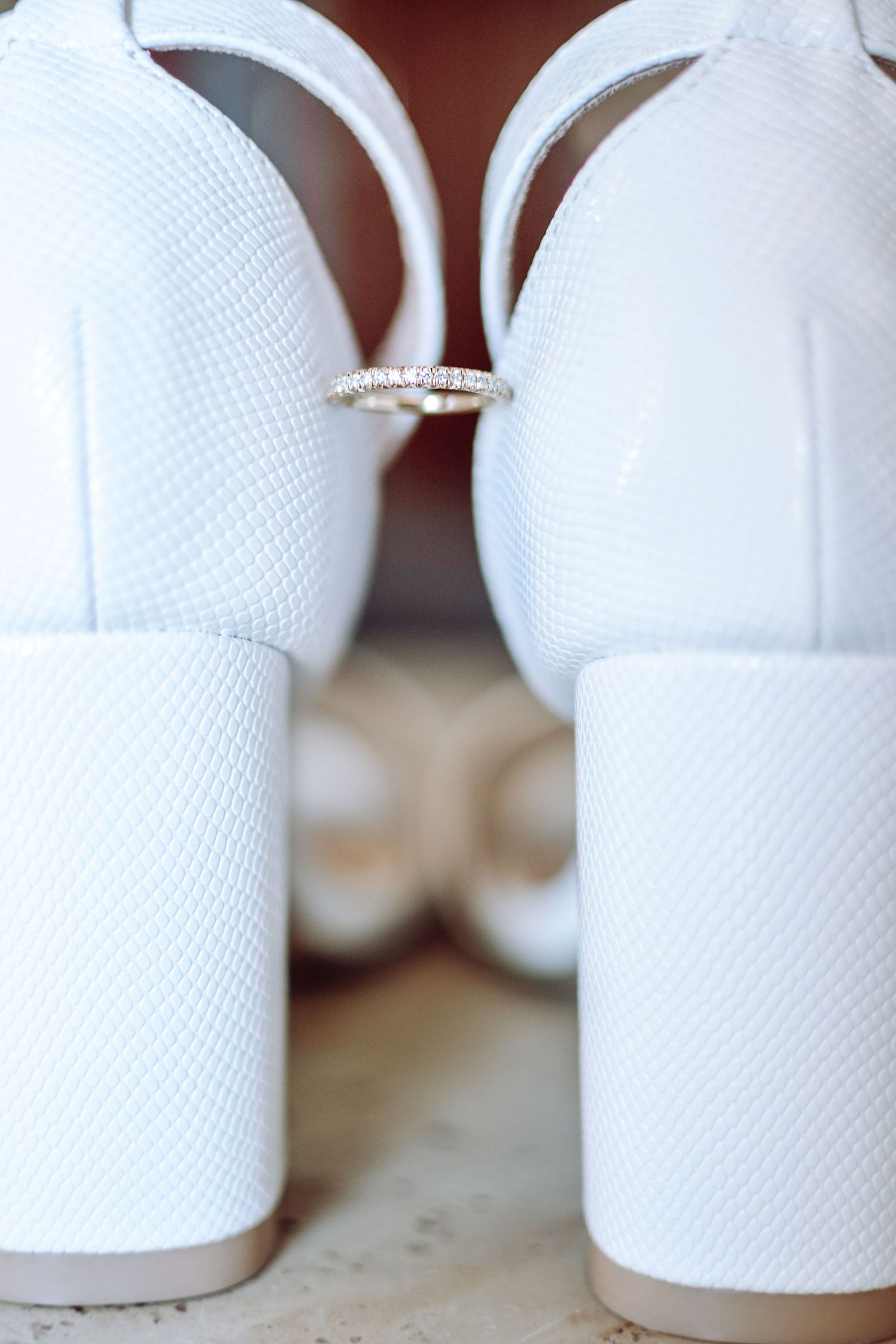 Close-up view of multiple white disposable paper towel rolls on a surface showing their textured pattern.