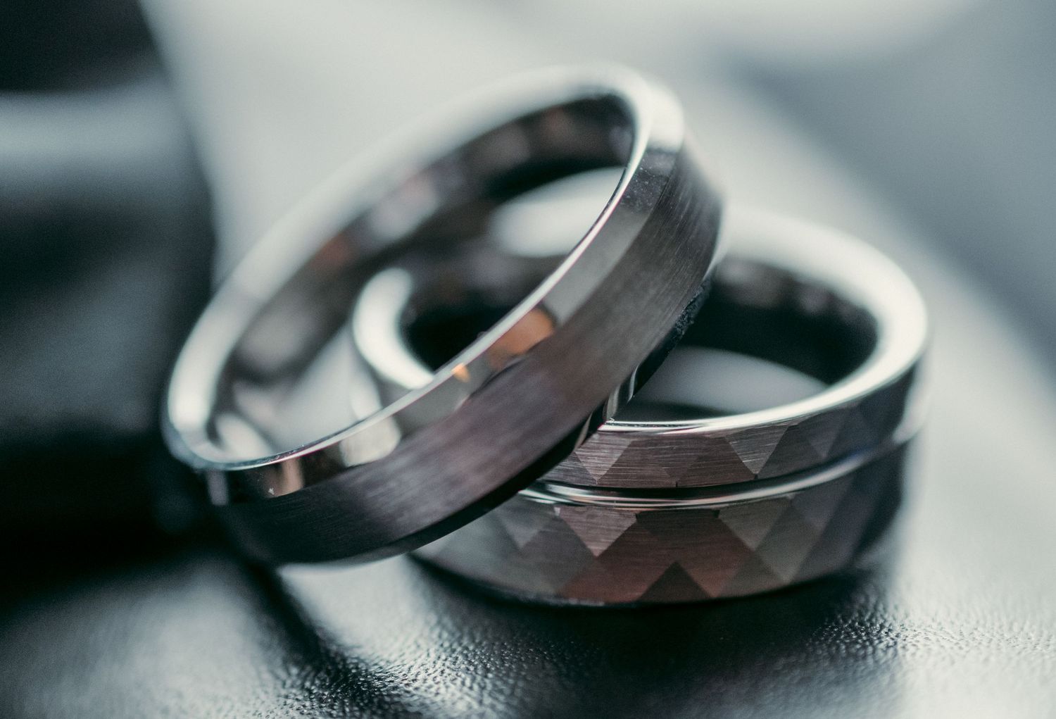 A series of close-up shots showing wedding rings on a dark textured surface in different angles and compositions.