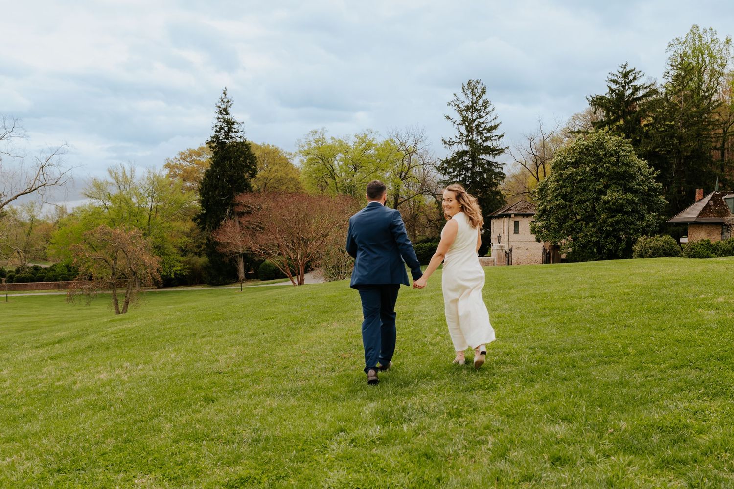 A collage of wedding photos shows a couple walking together through a green grassy hillside on a spring day.