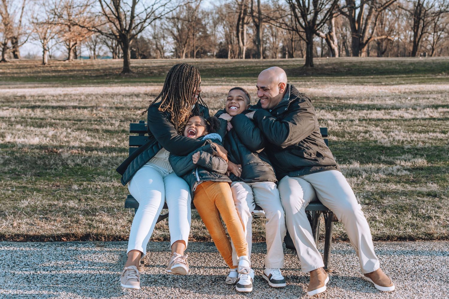 A playful group moment captured on a park bench during a fall day.