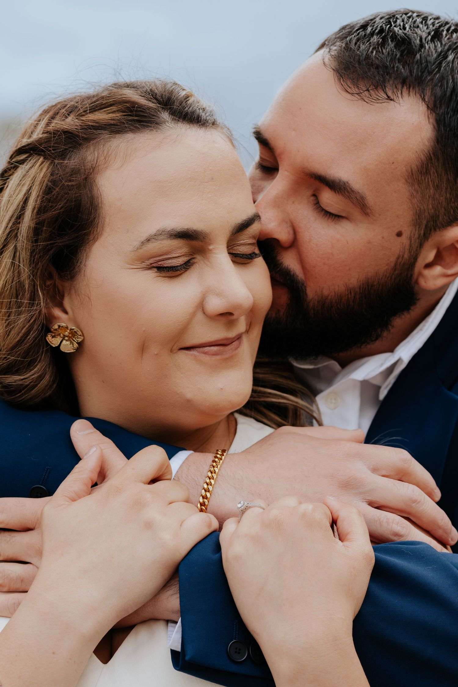 A series of romantic close-up shots showing tender embraces against a light background.