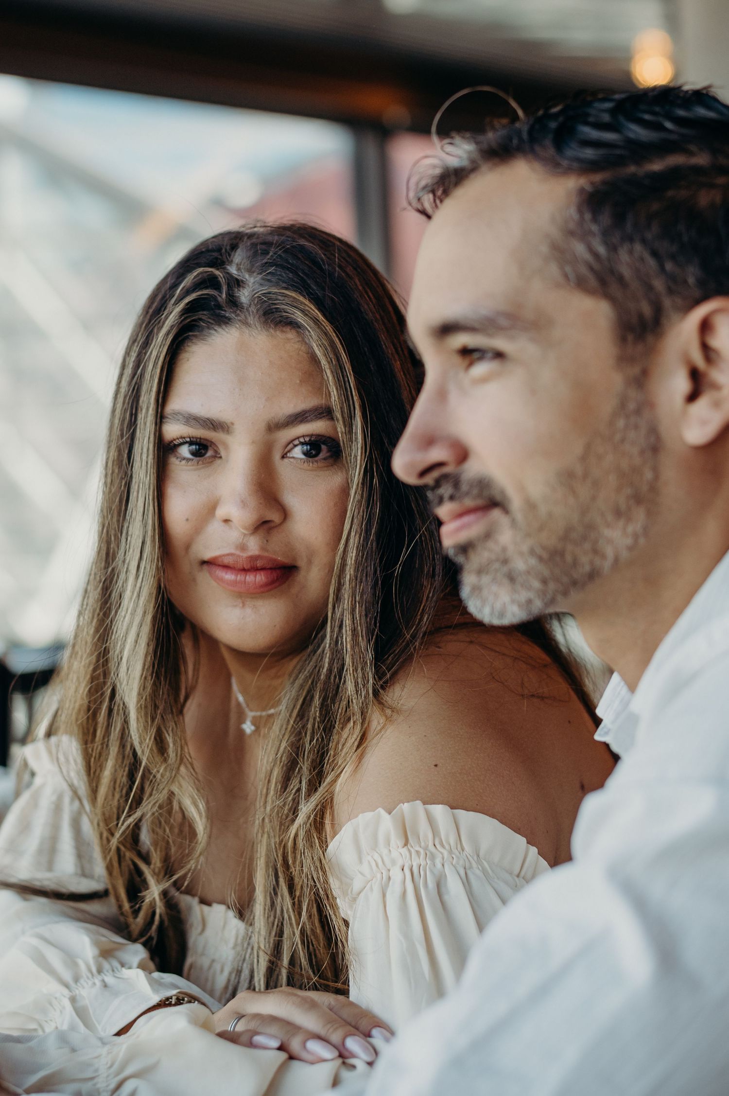 Tender close-up of a couple in white clothing sharing affectionate moments together.