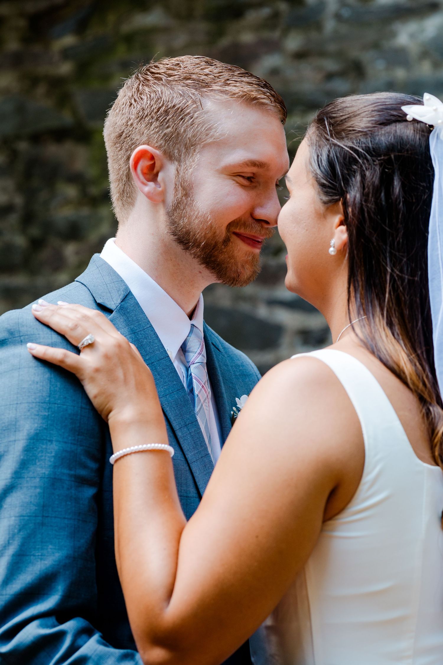 Intimate close-up wedding portrait showing tender moment between couple.