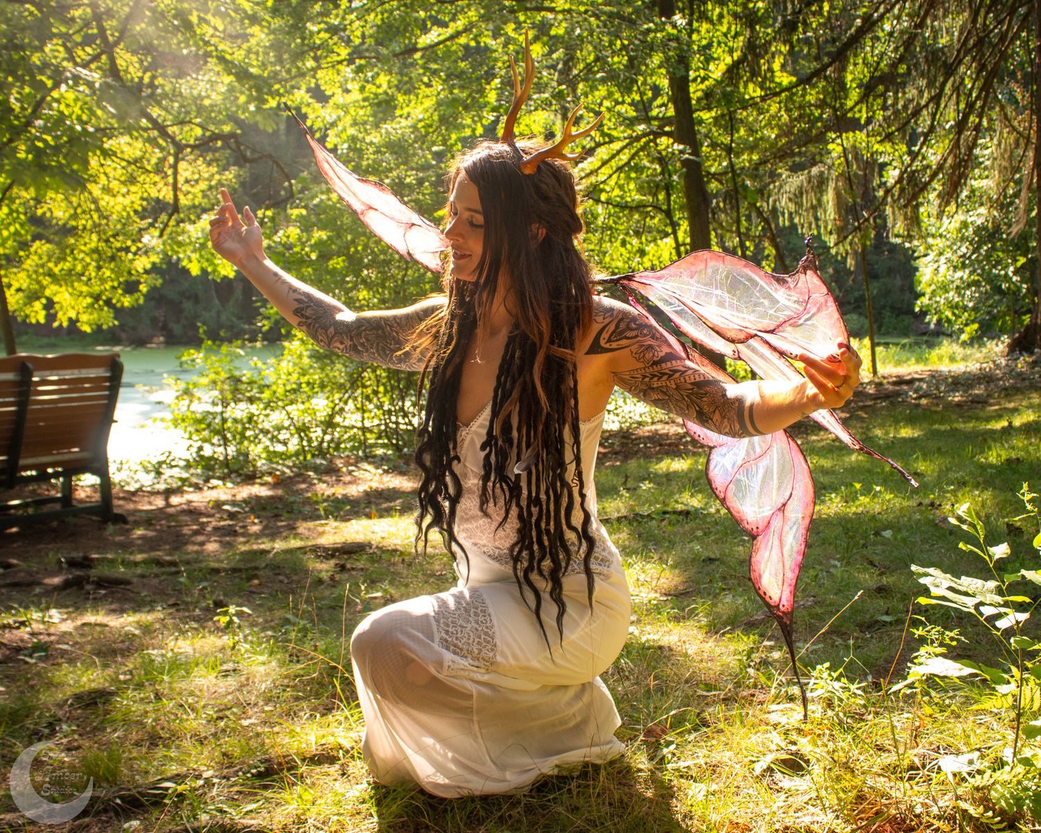 Dreamy forest photography with flowing dresses and ethereal poses.