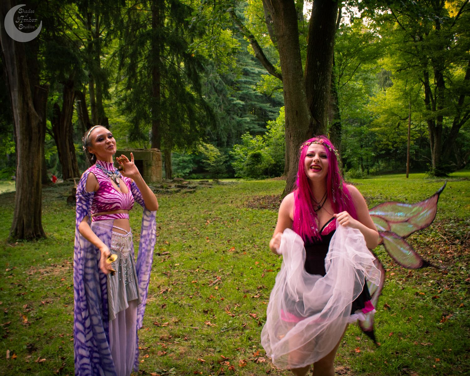 A whimsical forest photoshoot featuring flowy dresses and dreamy poses among tall trees in natural lighting.