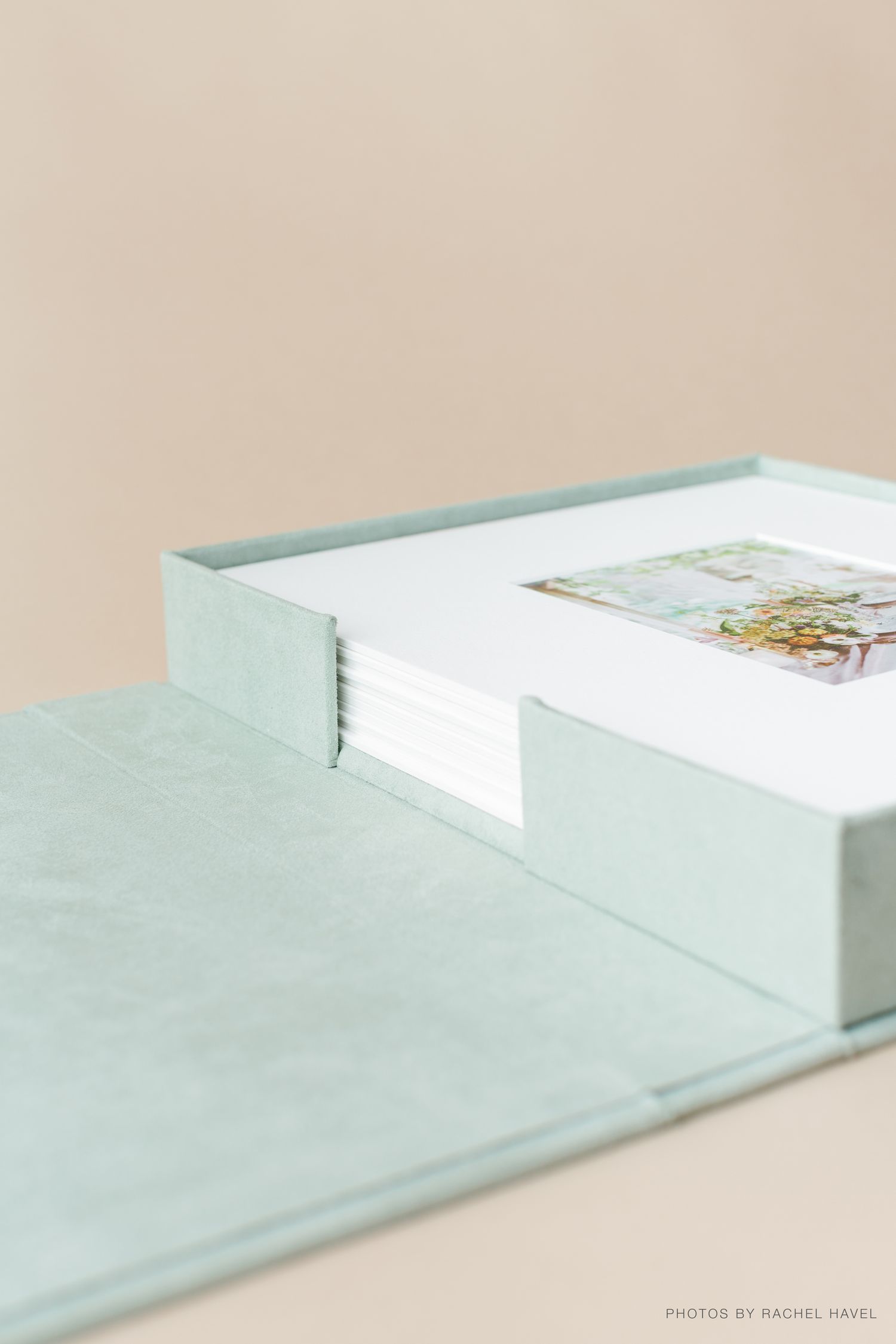 Minimalist composition of white paper envelopes with subtle blue-green tint arranged in a clean diagonal pattern.