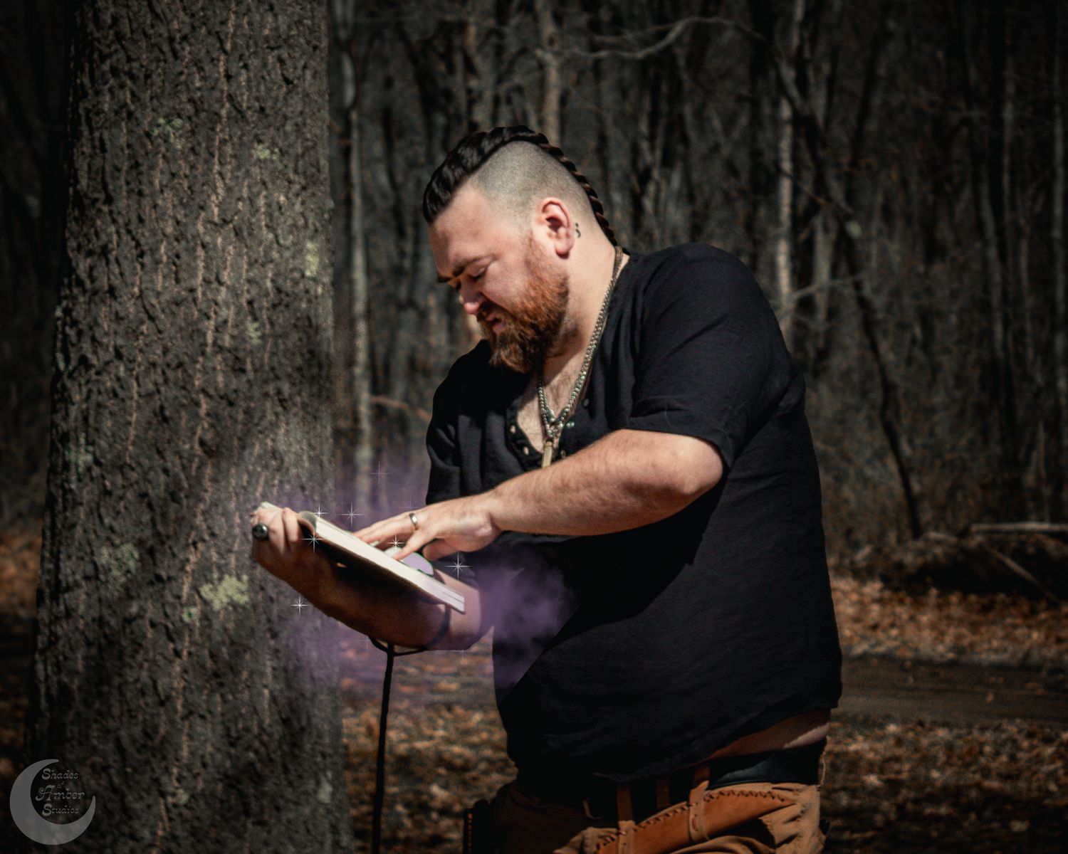 Man with mohawk reads glowing book in misty forest, purple smoke rising from pages in dramatic outdoor scene.