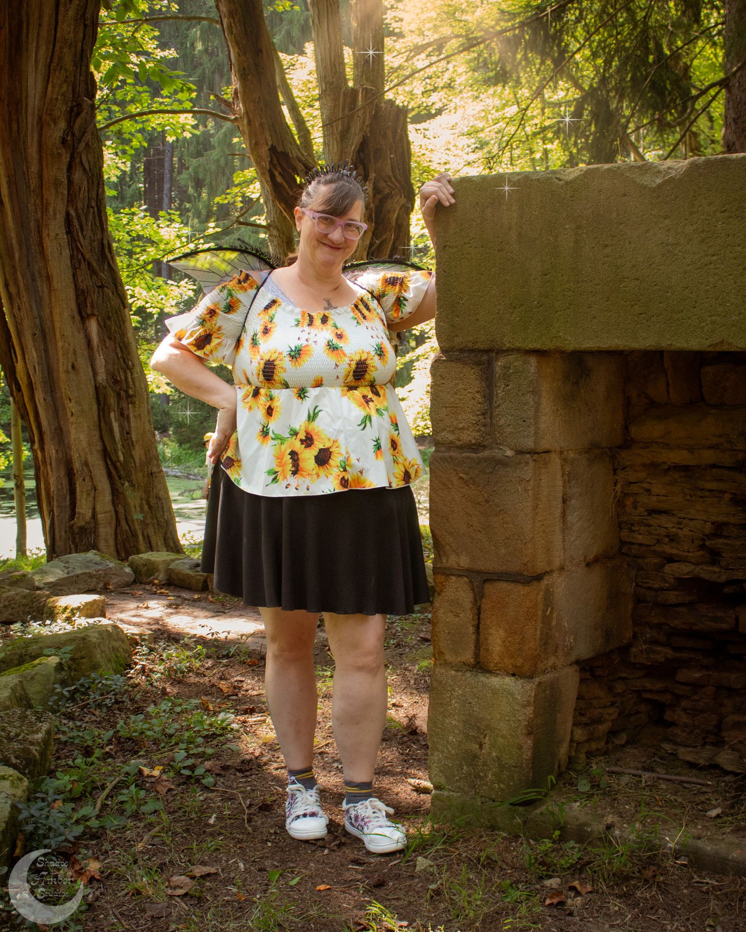 Rustic stone ruins in a wooded setting create an enchanting backdrop for a summer photoshoot.