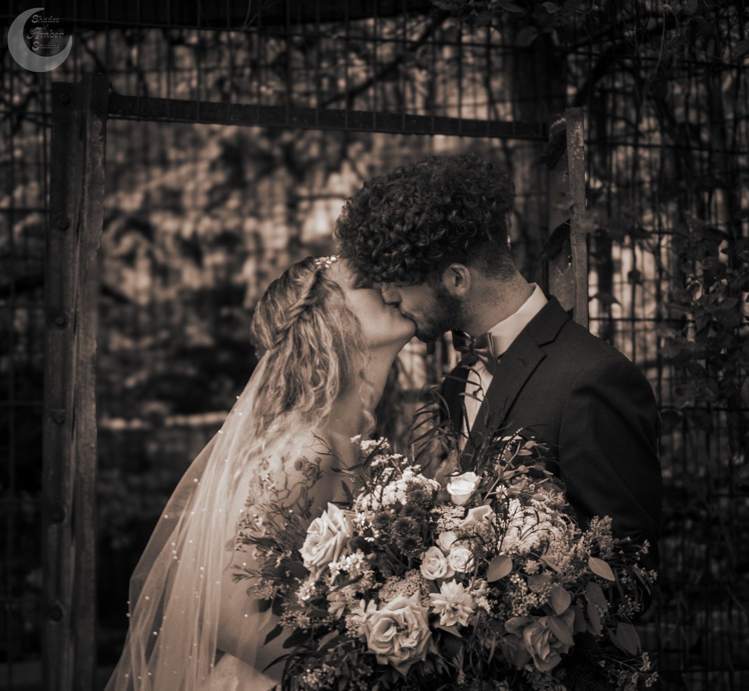 Black and white wedding ceremony photographs showing intimate moments between a couple during their outdoor vows.
