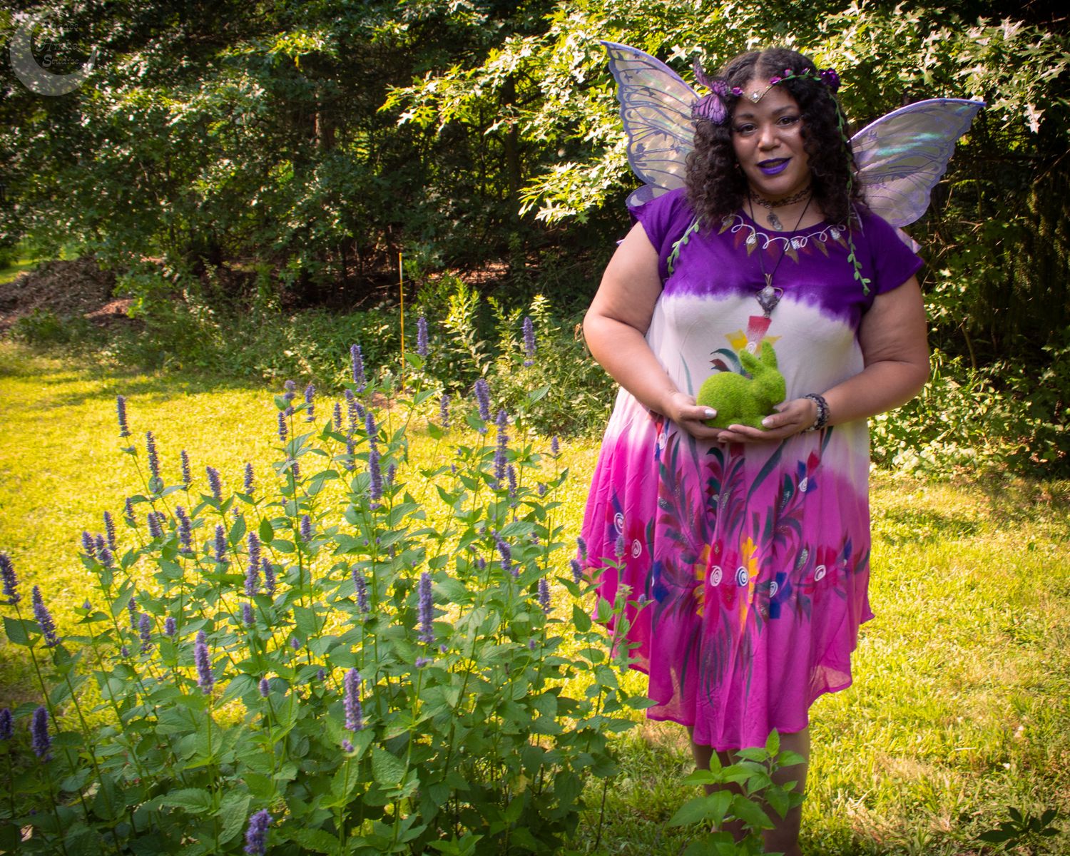 Person in bright pink dress twirls joyfully among yellow wildflowers in a sun-dappled meadow.