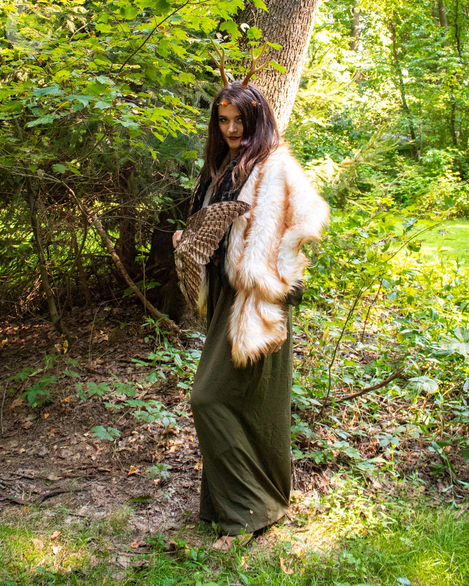 Forest photoshoot featuring olive green outfit against natural woodland backdrop.