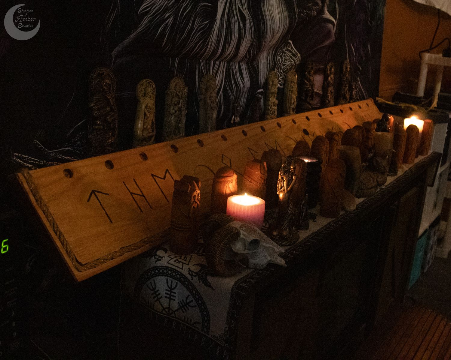A dark wooden altar with glowing candles illuminates mystical runes and spiritual objects in a dimly lit room.