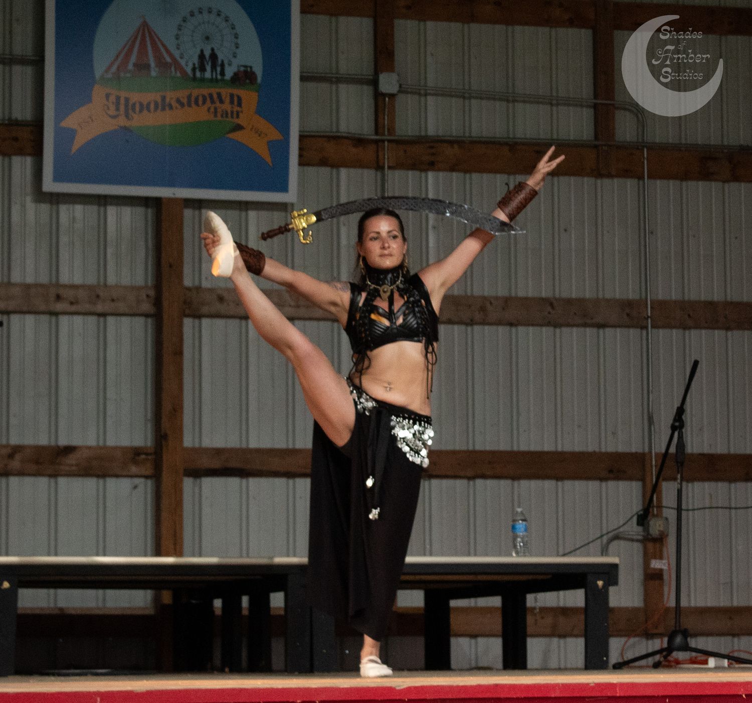 A person performs an acrobatic somersault sequence while doing parkour gymnastics in a indoor training facility.