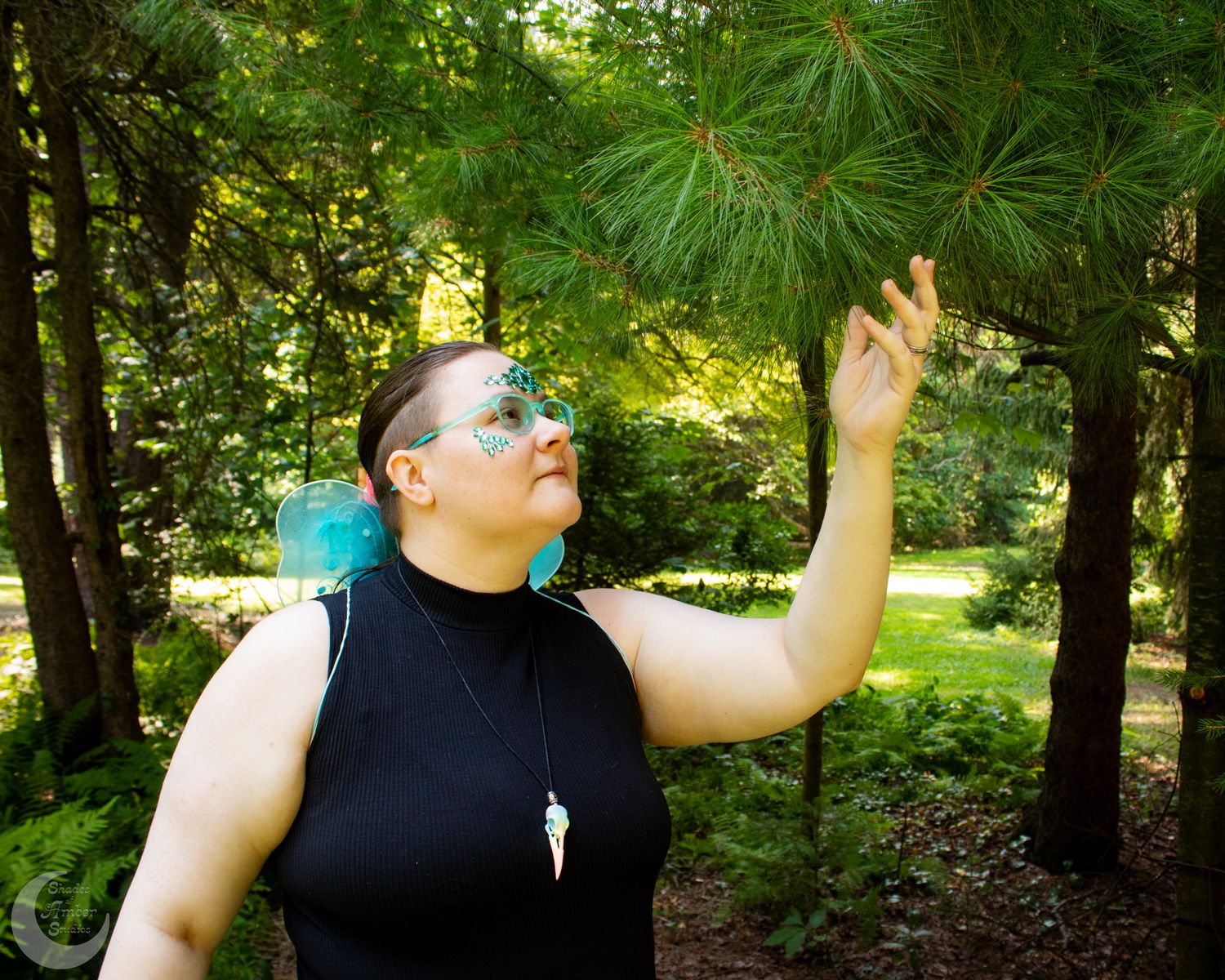 Expressive dance-like poses captured in a wooded outdoor setting.