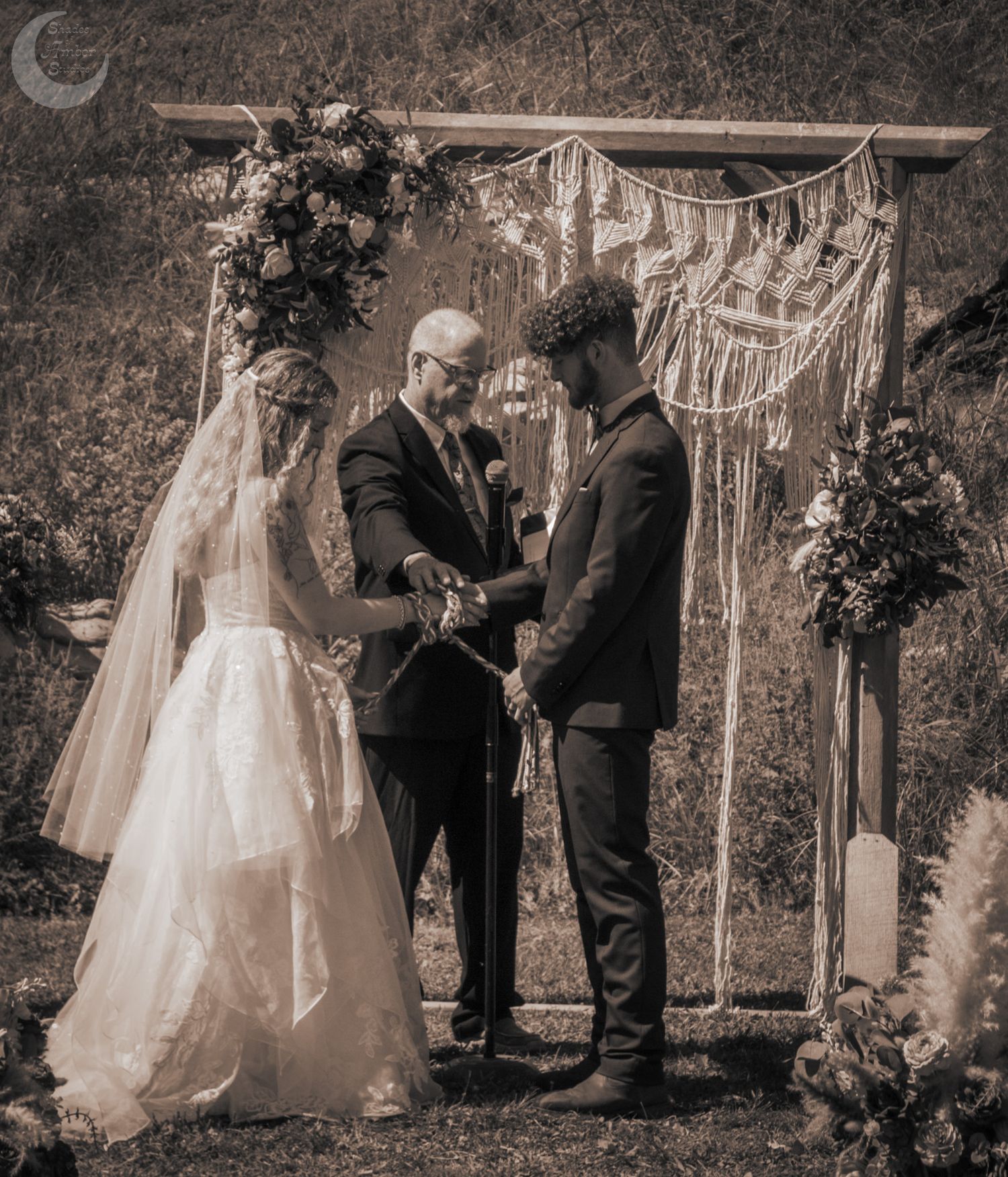 A romantic outdoor wedding ceremony sequence showing a couple exchanging vows under a macrame arch with floral decorations.