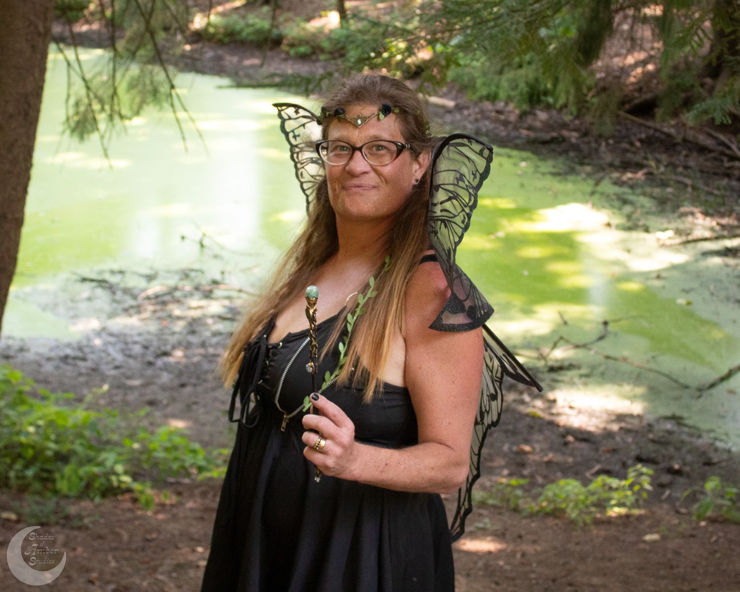 Enchanted forest themed photography with fairy wings and natural lighting.