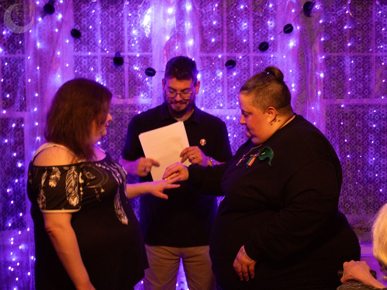 A ceremony scene with purple LED curtain lights creating a magical atmosphere.