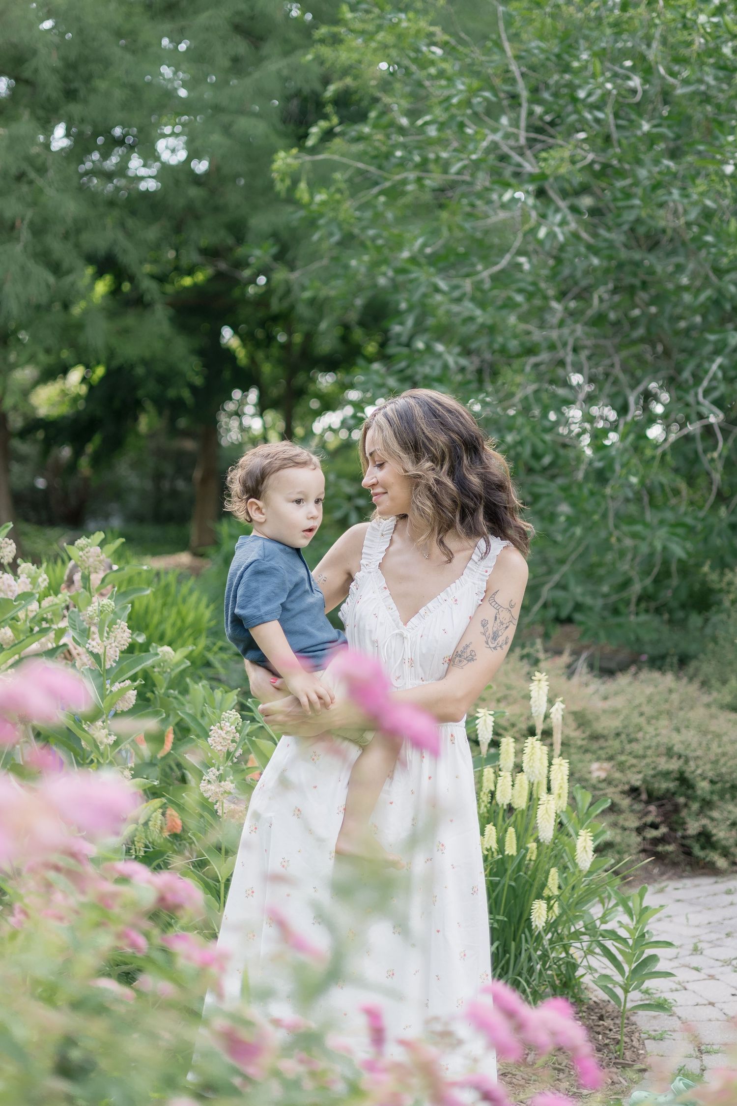 A sweet outdoor photoshoot among blooming flowers and greenery.