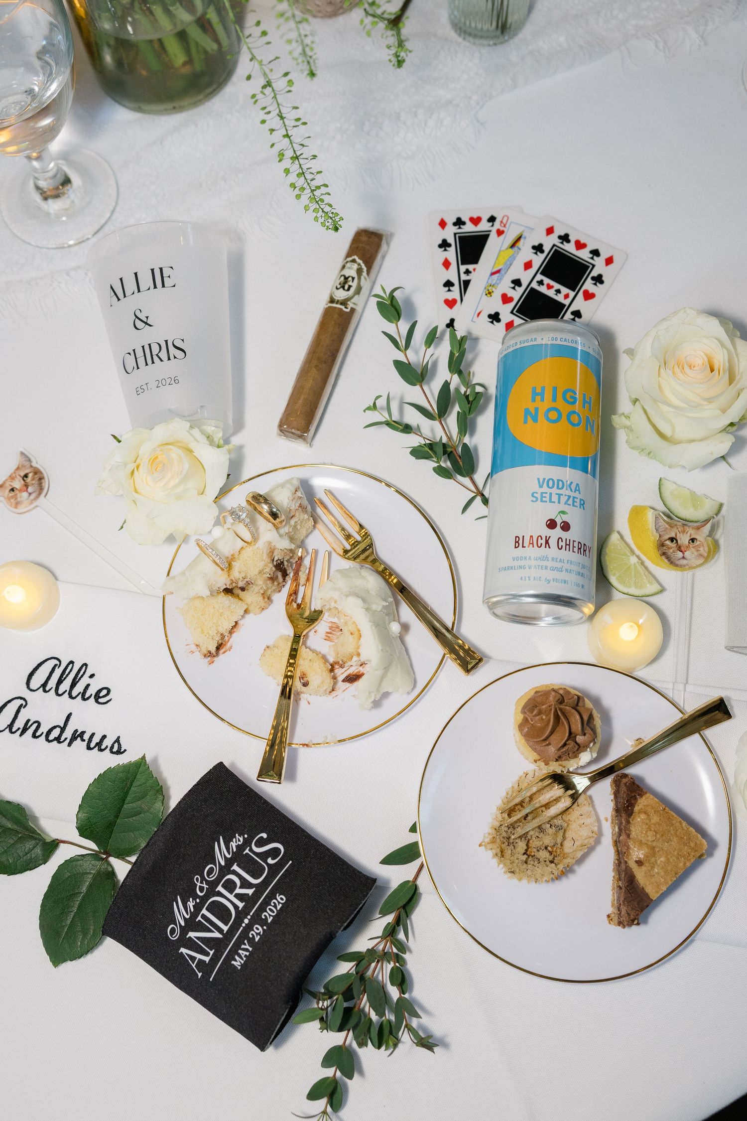 Wedding reception table with High Noon seltzer, cigar, playing cards, shrimp, desserts, and personalized decor.