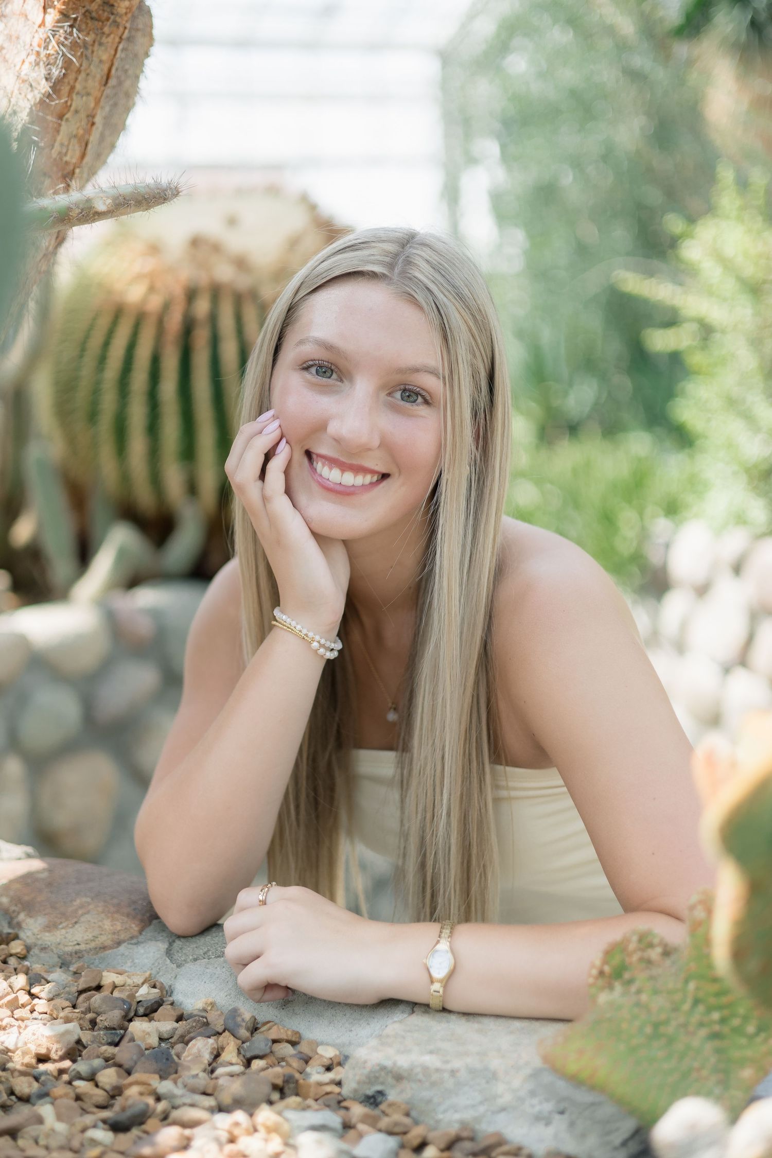 A series of outdoor portrait photos showing someone lying on rocks in natural lighting with a soft smile.