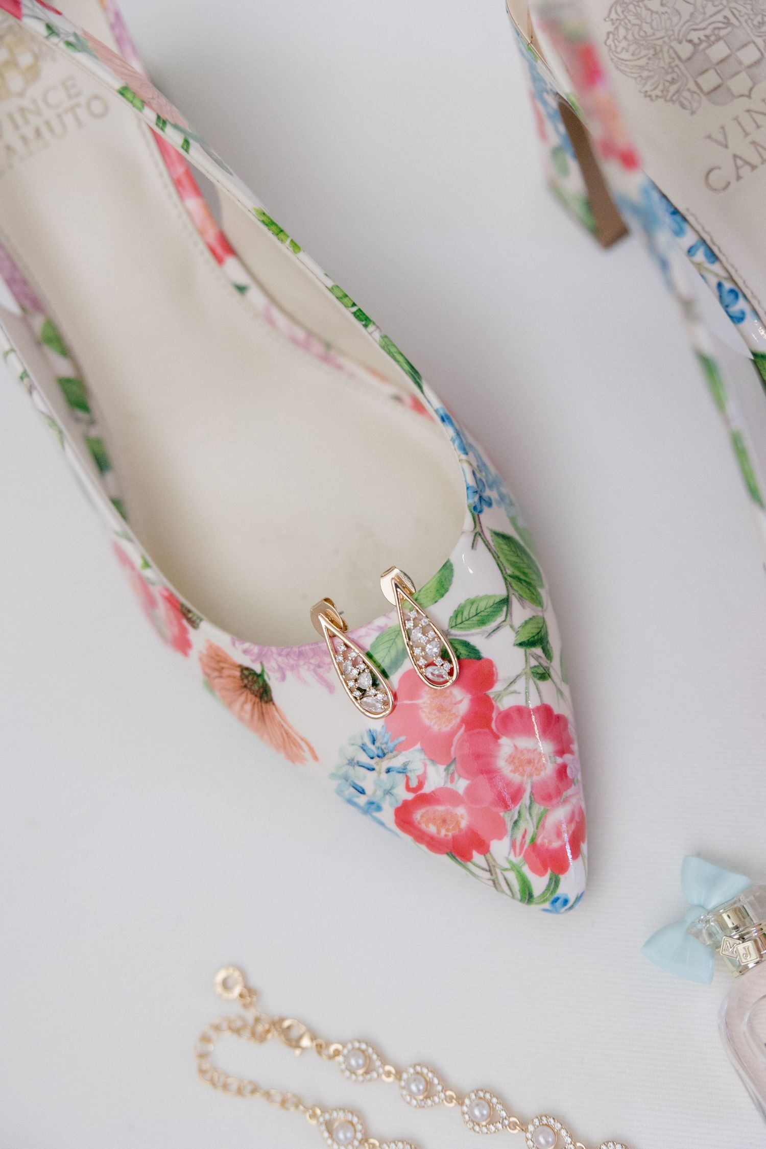 Floral print wedding shoe with delicate jewelry details on white background.