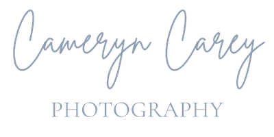 A handwritten cursive text in blue ink displays 'Tamryn Marcy Photography' against a white background.