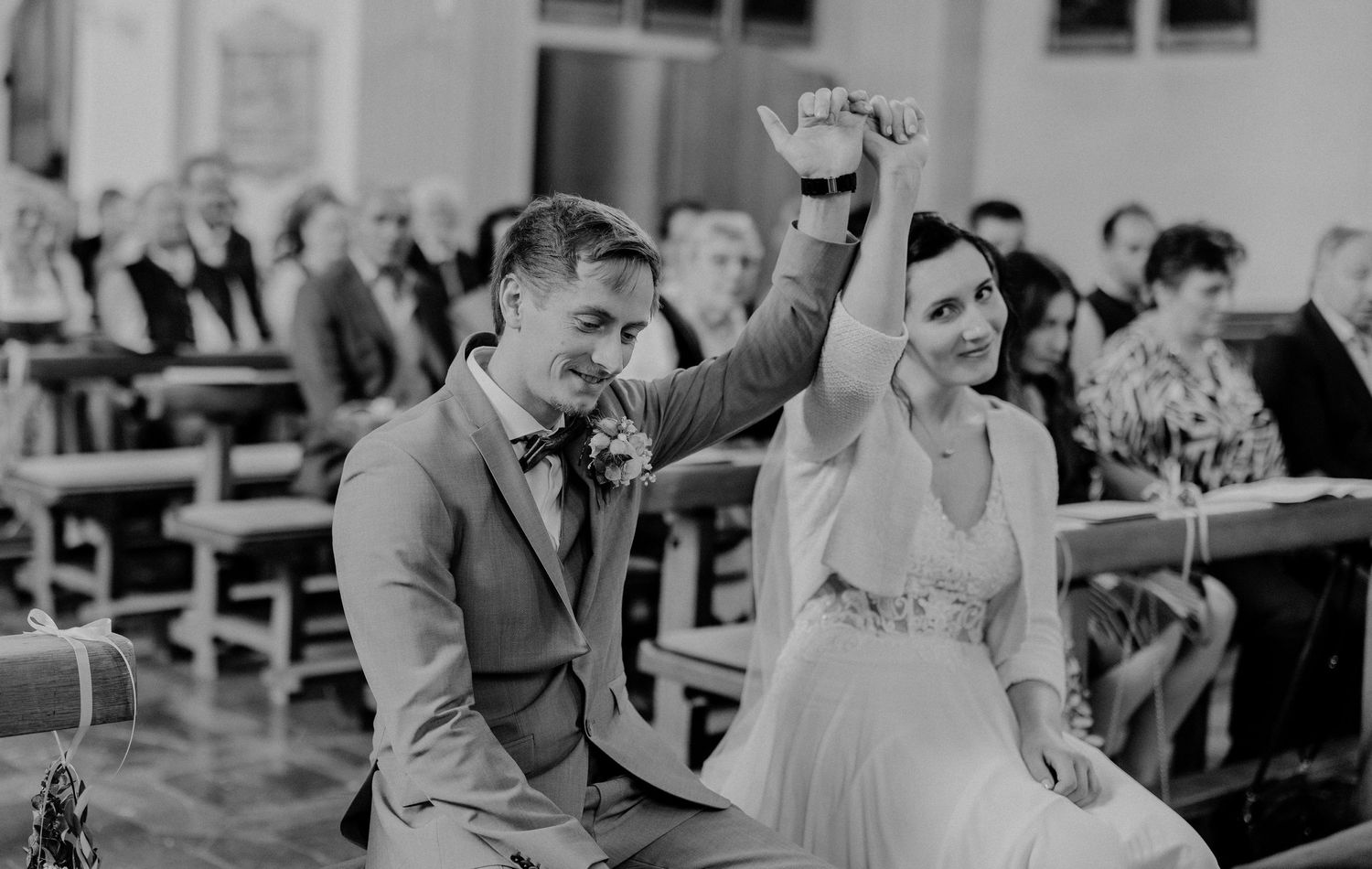 A celebratory moment captured during a wedding ceremony outdoors.