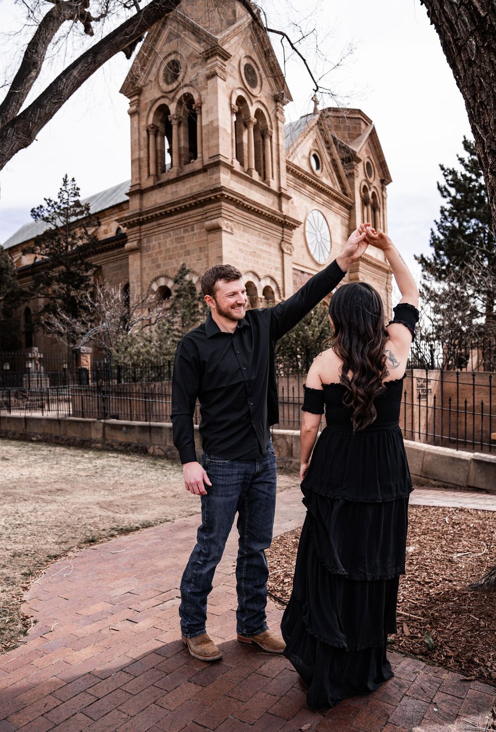 A couple dancing in front of the Cathedral Basilica of St. Francis in Santa Fe