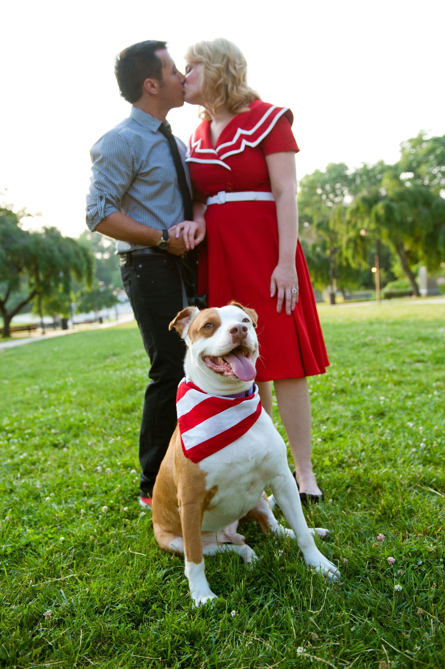 Engagement session of couple kissing with their dog in the picture