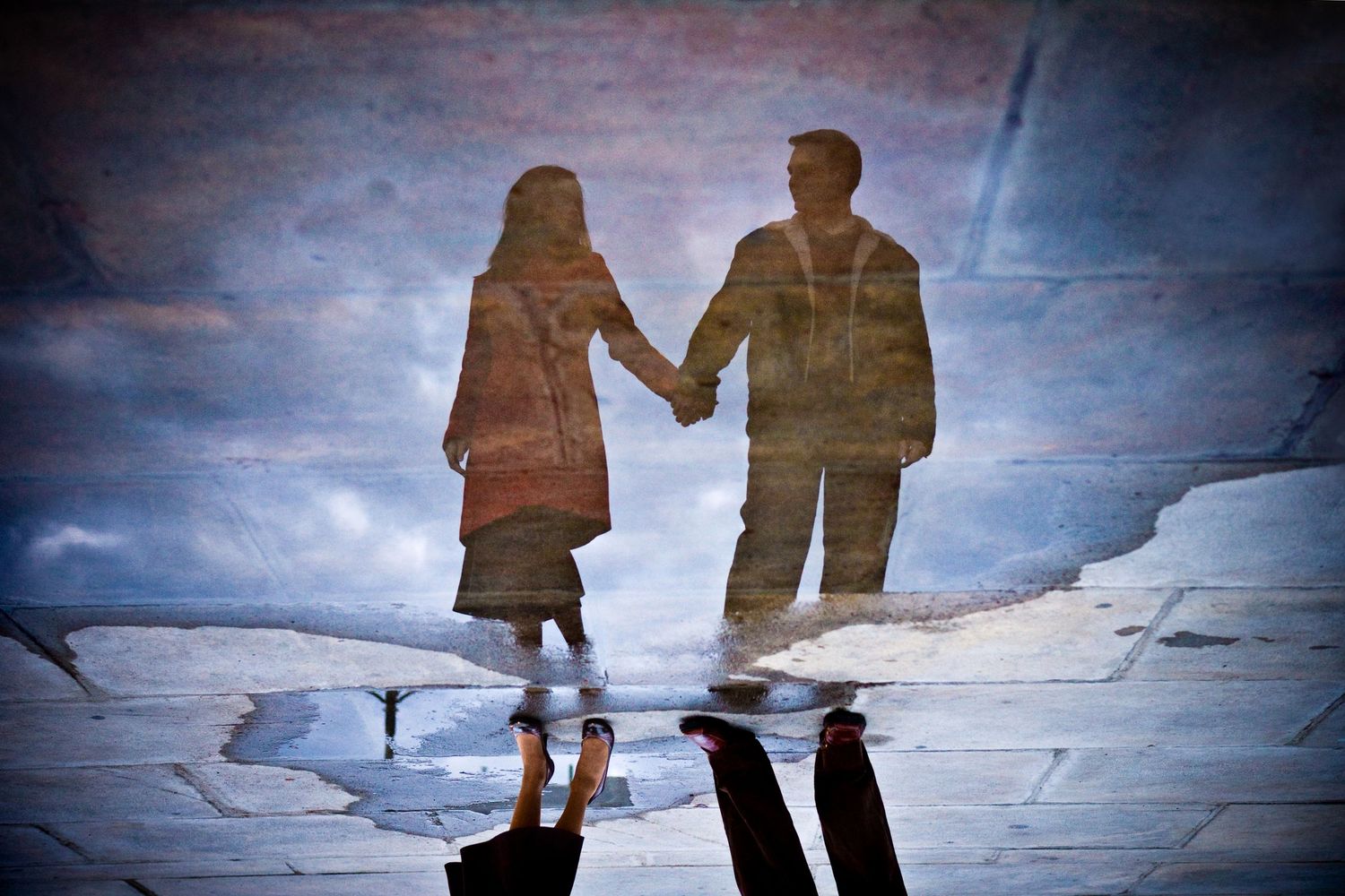 Artistic shot of a couple in a puddle in downtown Philadelphia