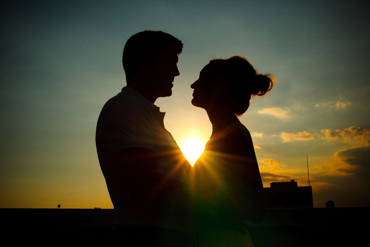 Silhouette of a couple at sunset during engagement session.