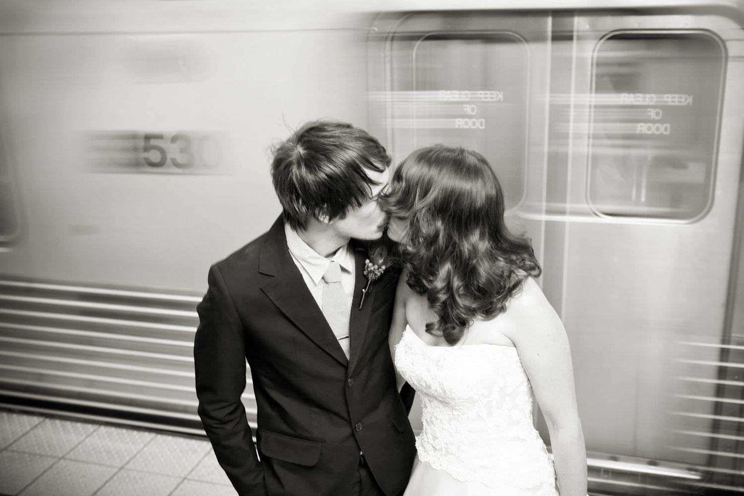 Urban photo of couple kissing in subway