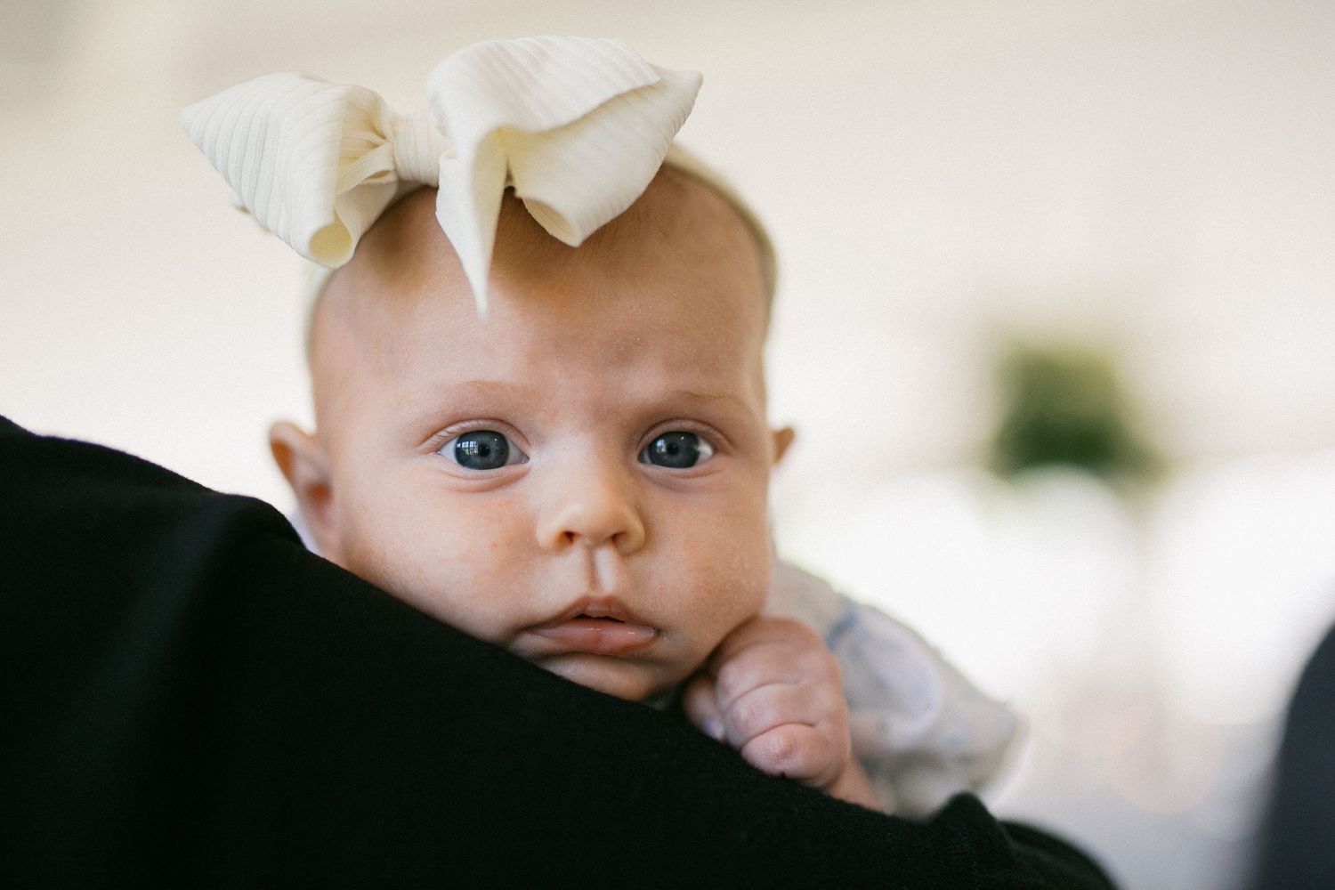 Close-up view of baby's eyes and face in soft natural lighting.