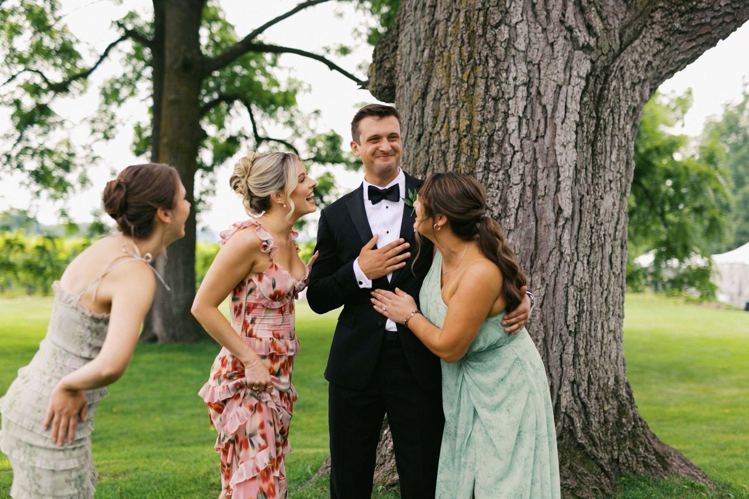 A groom and bridesmaids share an emotional moment during the wedding.