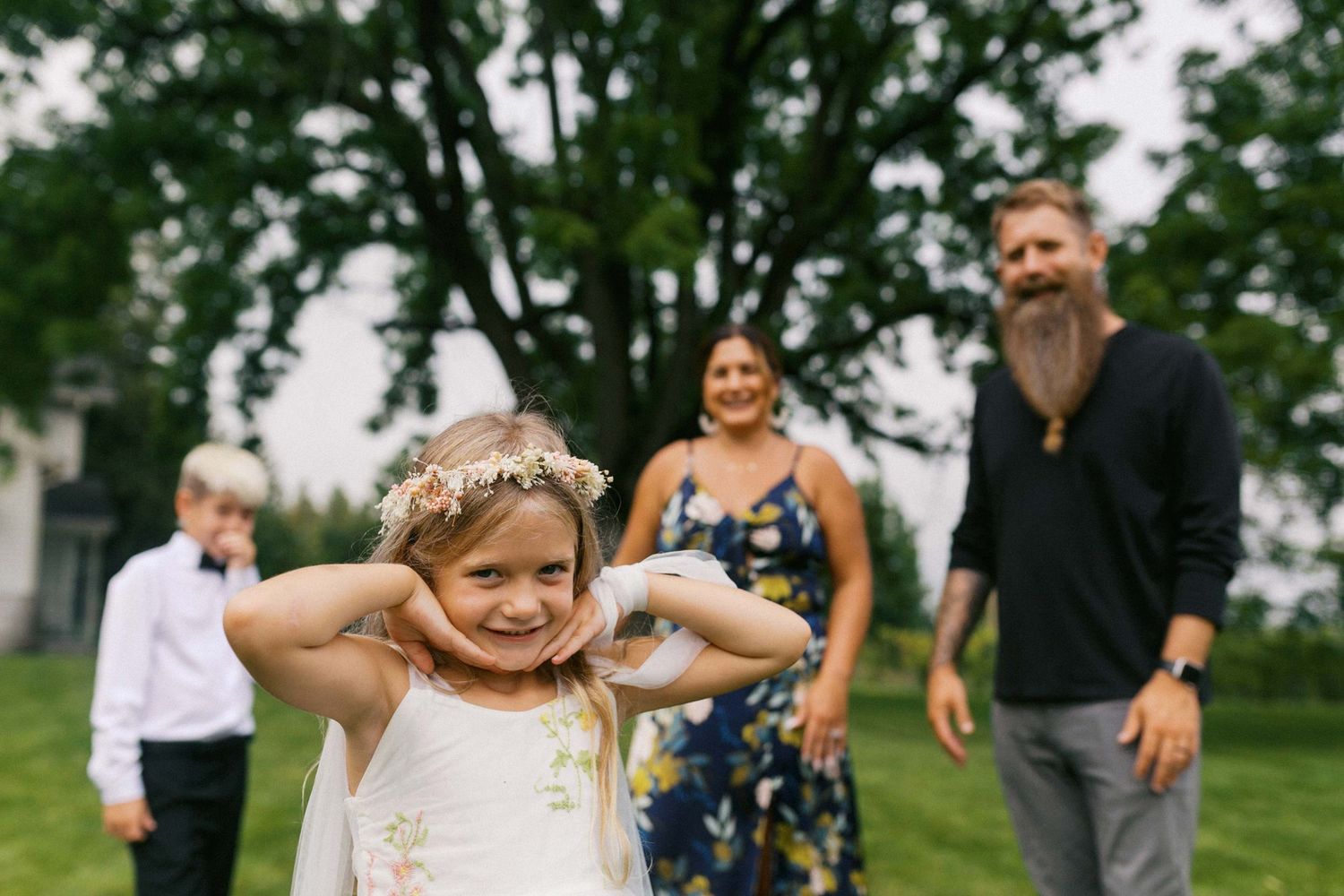 A series of candid wedding photos showing joyful moments between the wedding party outdoors in a green field.