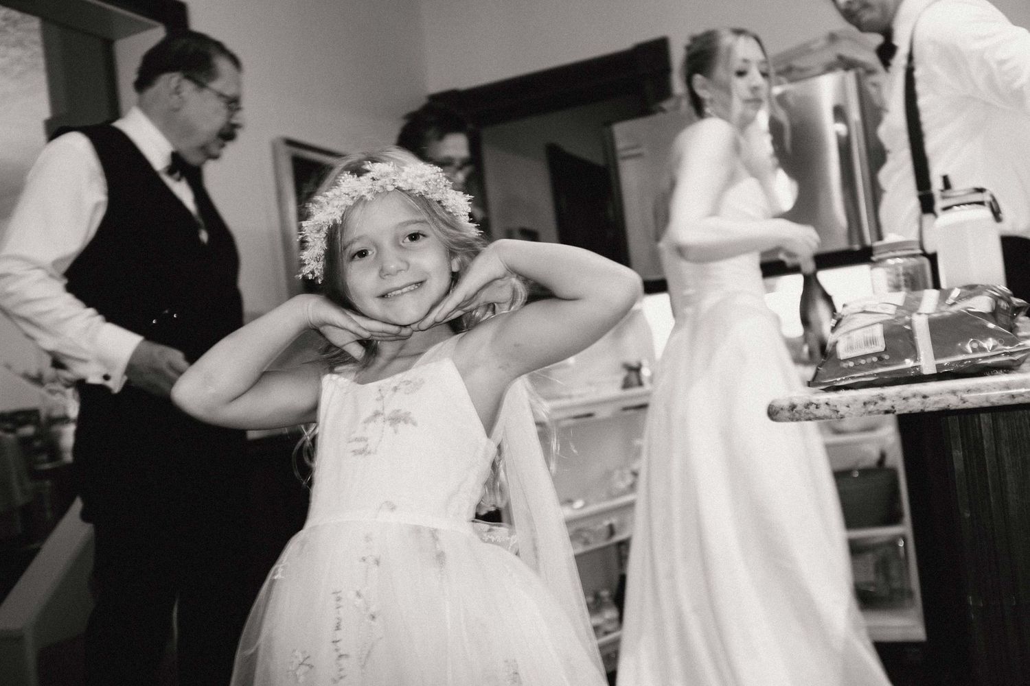 A young flower girl poses for a photo.