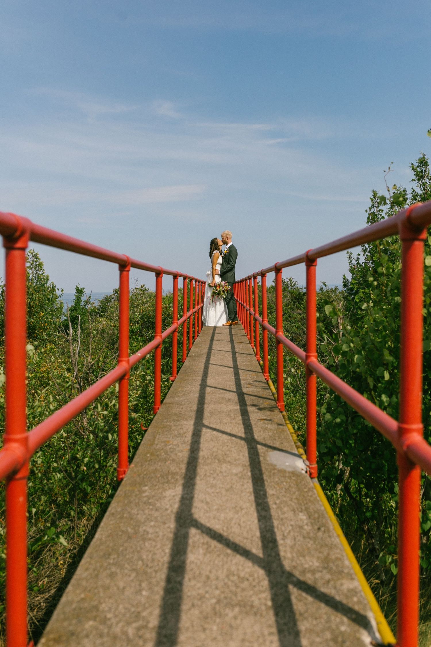 Red-railed walkway leading to a scenic overlook point.