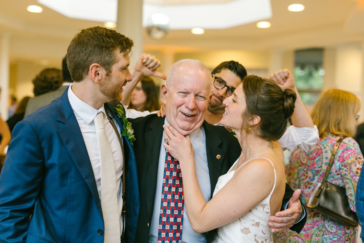 People share a joyful moment at an indoor celebration with warm lighting and festive atmosphere.