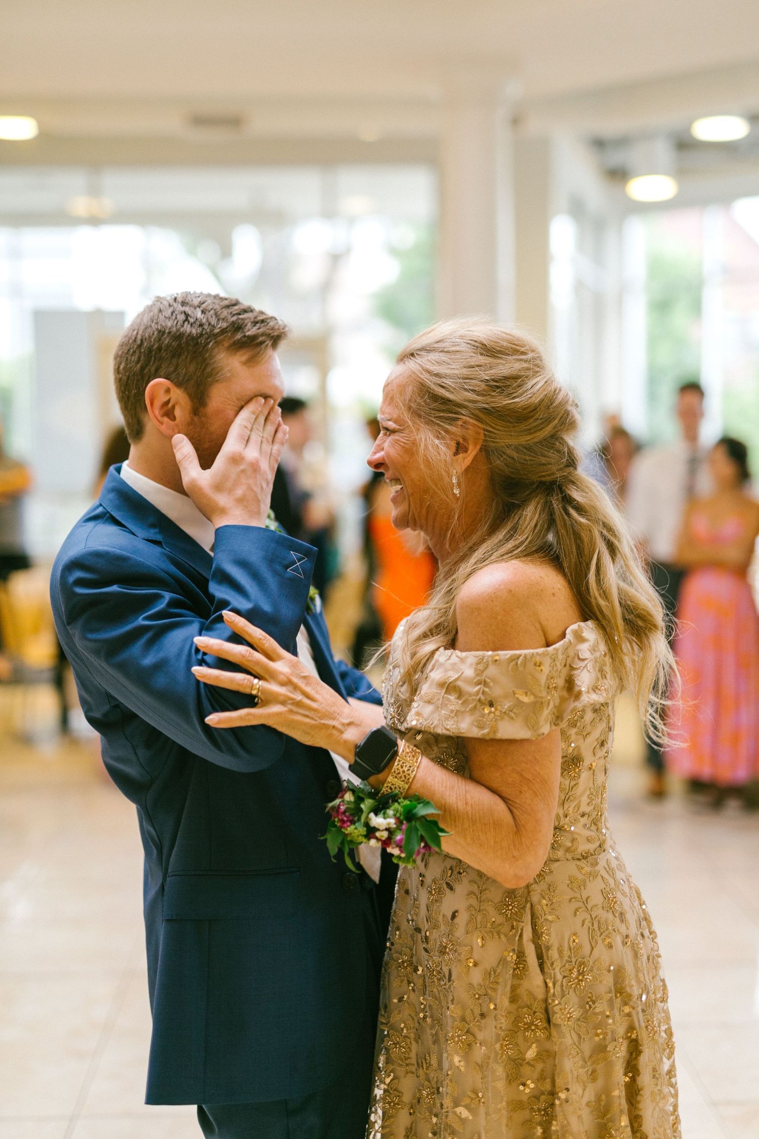An emotional moment captured between two people during a formal dance in an indoor venue.