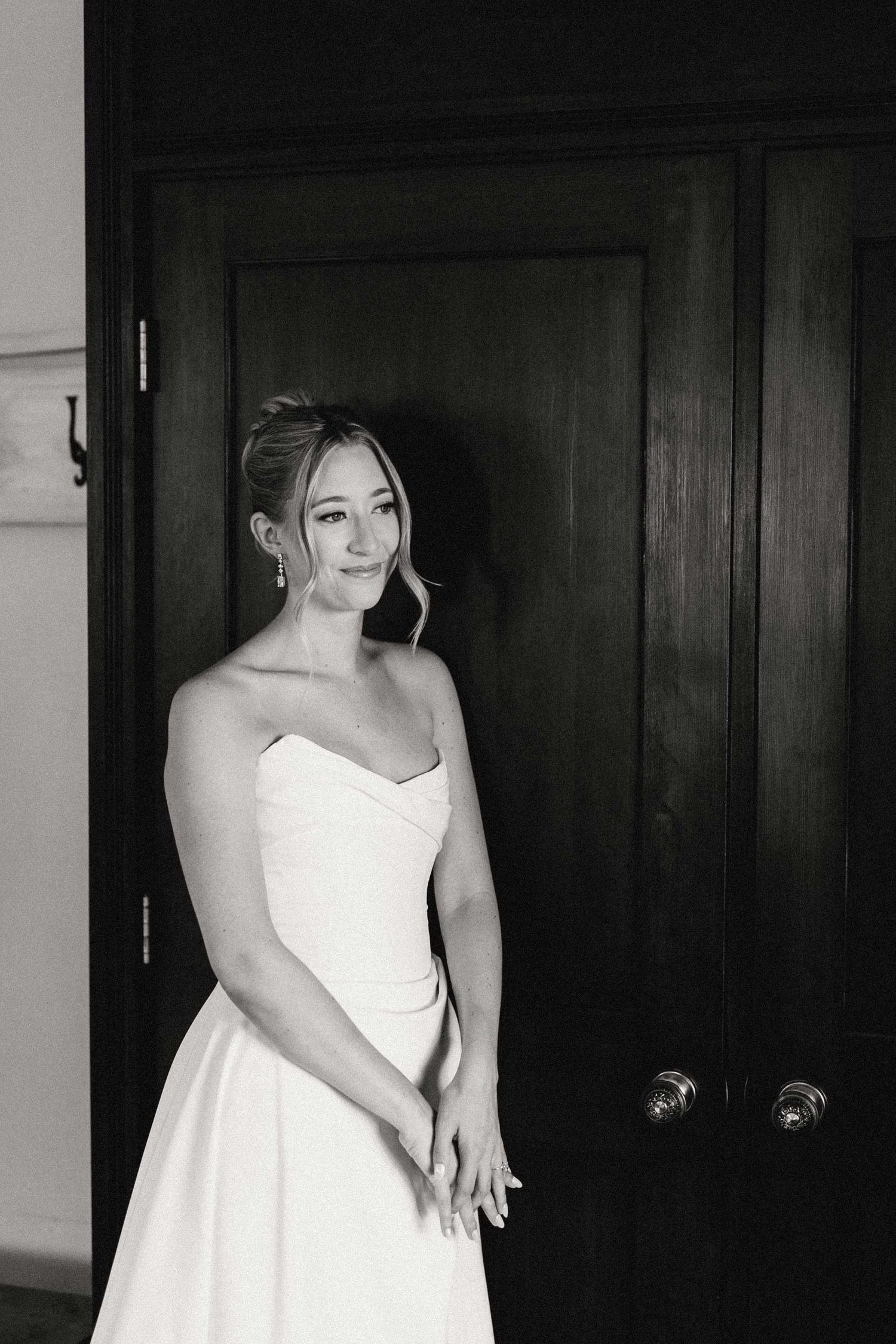 A black and white photo collage shows someone in a white dress posing against dark wooden doors.