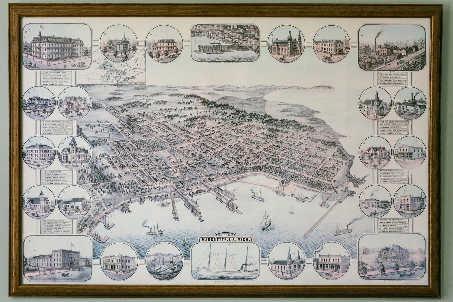 A collection of vintage framed panoramic maps showing aerial views of historic cities and towns.