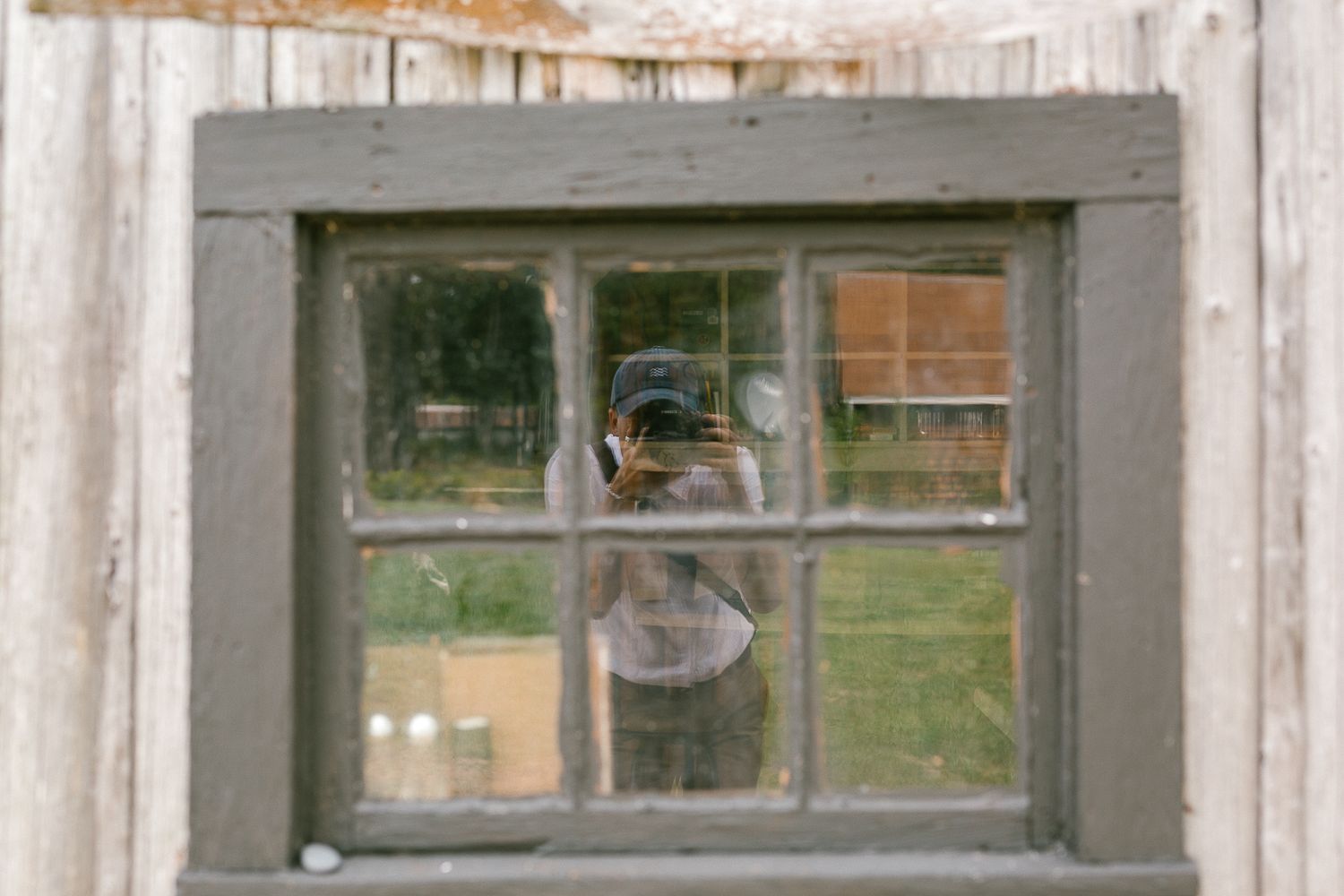 Rustic wooden window frames create a vintage architectural detail.