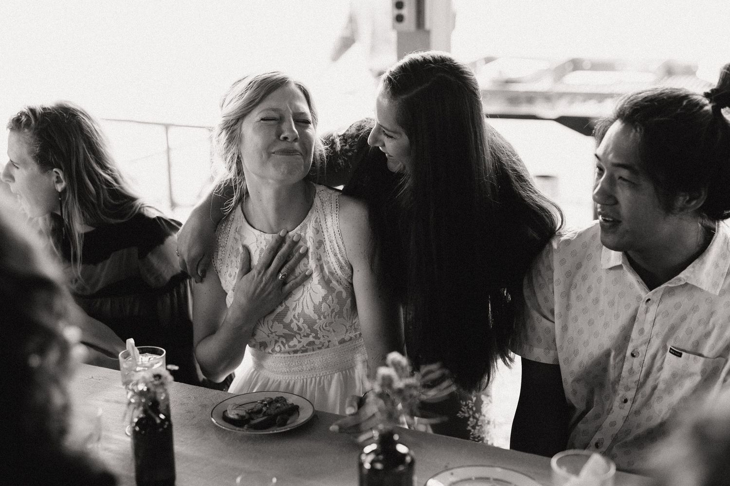 A candid moment of laughter and joy during a casual outdoor wedding reception.