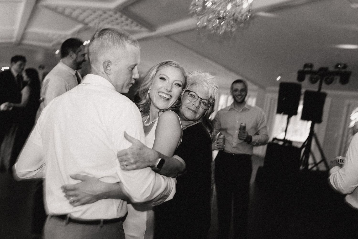 Black and white dance floor montage showing couples embracing during romantic slow dances at an indoor event.