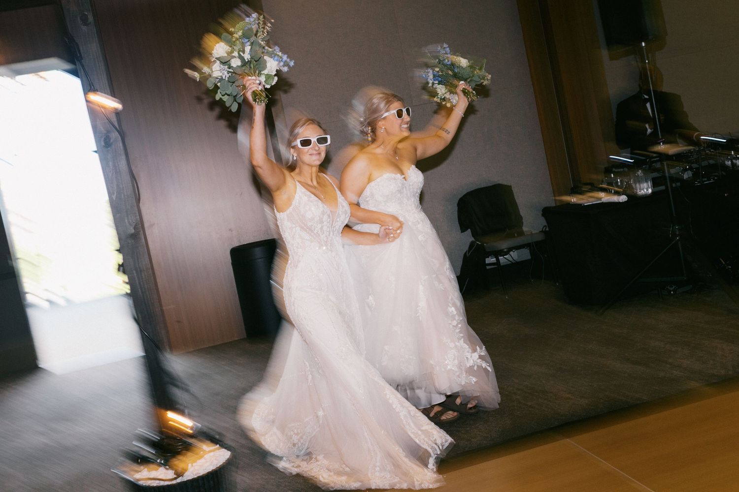 A playful wedding scene with a bride in a white dress twirling and dancing in a joyful celebration.
