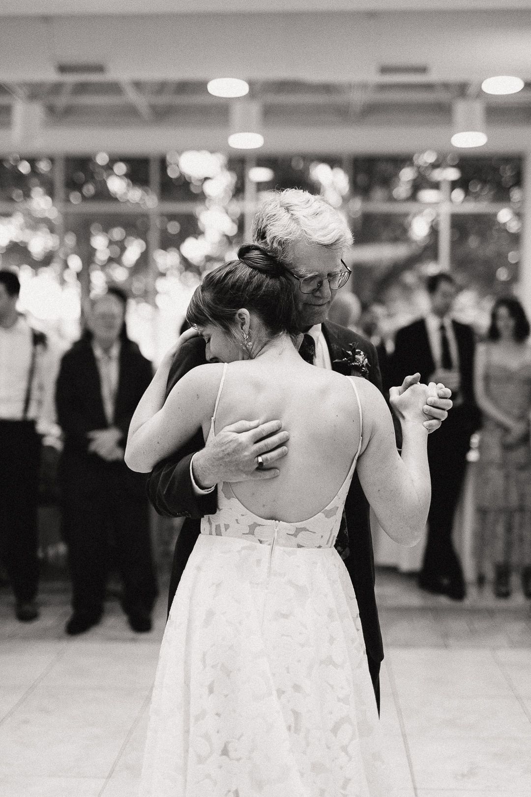 Couples dancing together at an elegant indoor reception venue.
