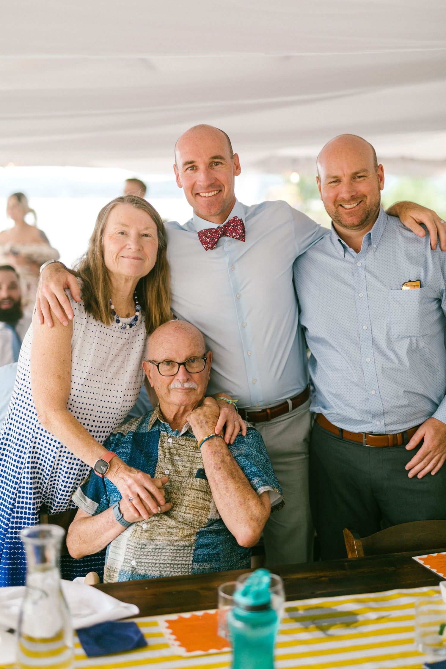 A group of family members gather close together at a casual celebration event.
